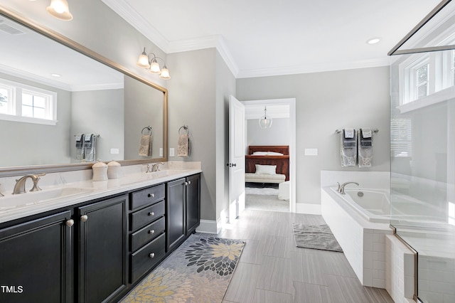 bathroom with vanity, crown molding, and tiled tub