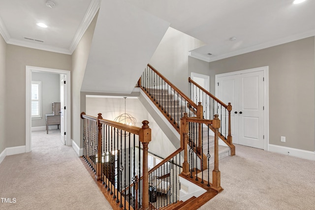 stairway with ornamental molding, carpet, and a chandelier