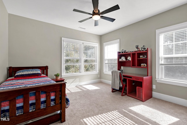 bedroom featuring visible vents, a ceiling fan, baseboards, and carpet floors