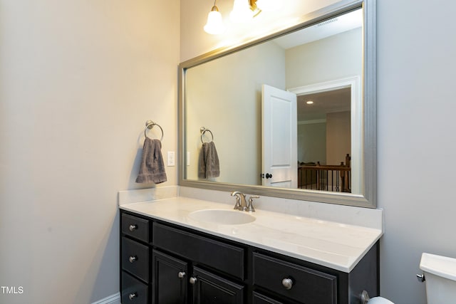 half bath featuring toilet and vanity