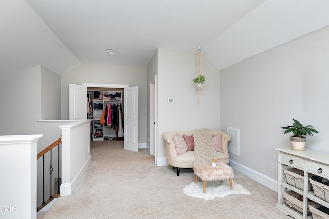 living area featuring vaulted ceiling and light colored carpet