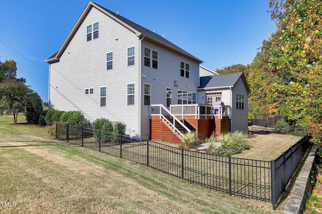 rear view of property with a fenced backyard, stairs, a lawn, and a deck