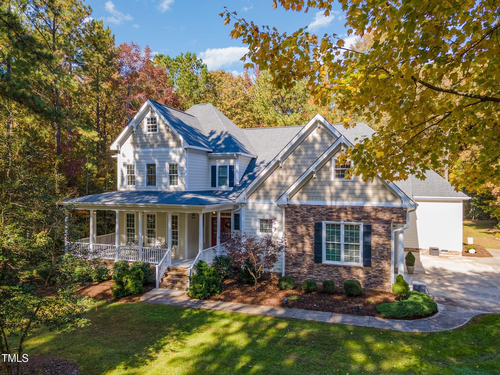 view of front of home with a porch and a front yard