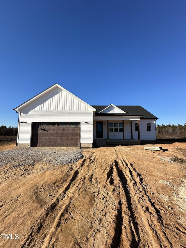 view of front of home featuring covered porch and a garage