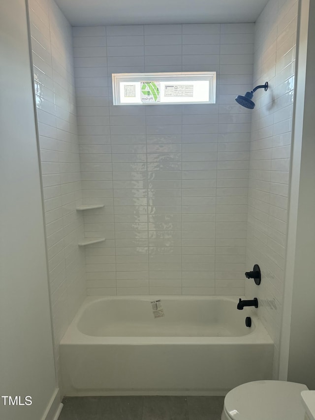 bathroom with toilet and washtub / shower combination