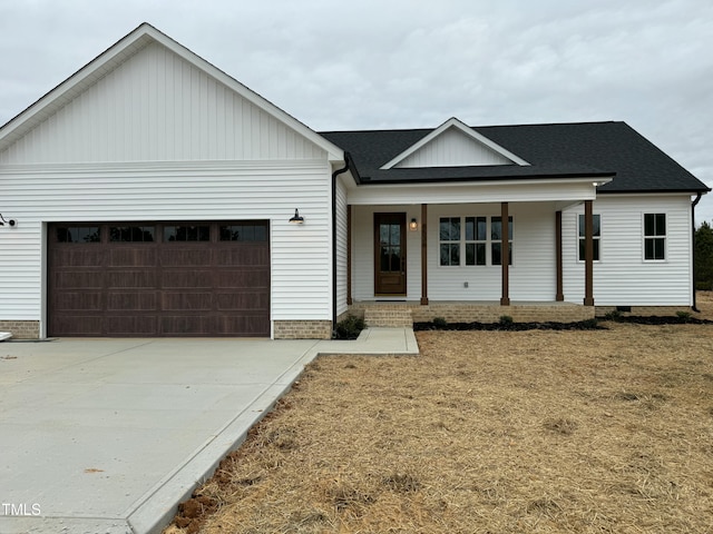 modern farmhouse style home featuring a shingled roof, concrete driveway, an attached garage, covered porch, and crawl space