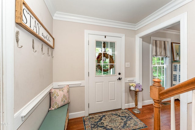 doorway featuring crown molding and hardwood / wood-style flooring