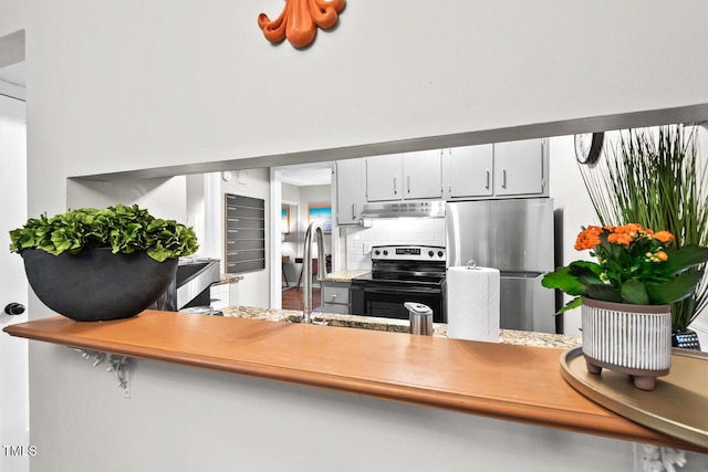 kitchen with tasteful backsplash, white cabinetry, and stainless steel appliances