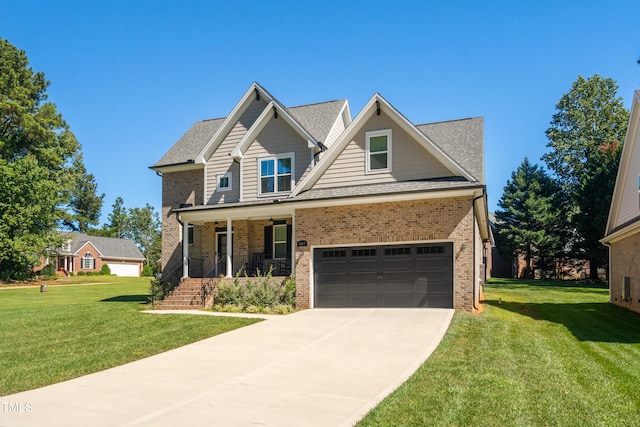 craftsman house with a porch, a garage, and a front lawn