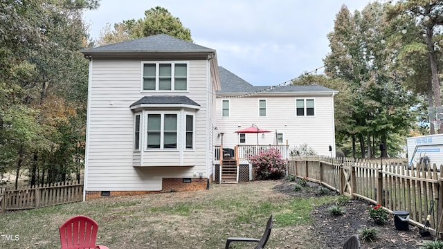 rear view of house with a wooden deck