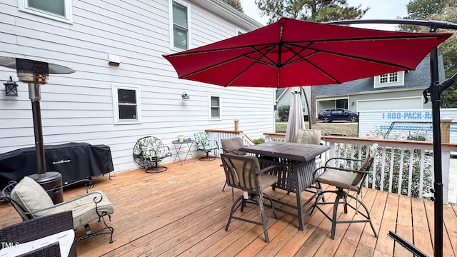 wooden terrace featuring a grill