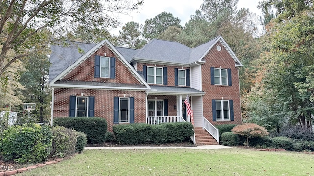 view of front of home featuring a porch and a front lawn