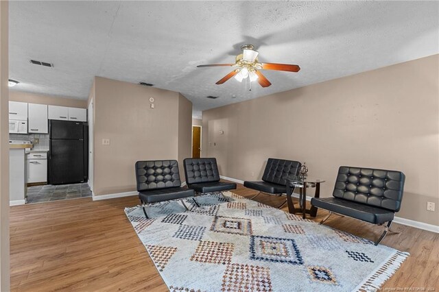1018 Wood Creek Dr Unit 3, Fayetteville, NC 28314 - living area featuring ceiling fan, light wood-type flooring, and a textured ceiling