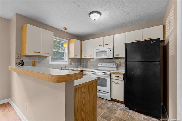 1018 Wood Creek Dr Unit 3, Fayetteville, NC 28314 - kitchen with white appliances, a peninsula, pendant lighting, tasteful backsplash, and a textured ceiling