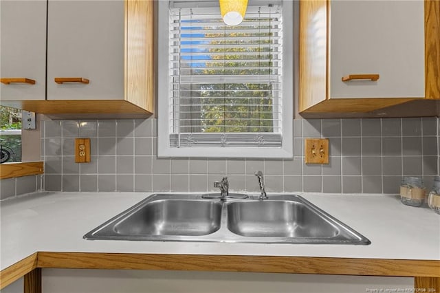 kitchen featuring sink and backsplash