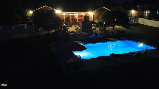 166 Weldon Dr, Clayton, NC 27520 - pool at night featuring a fenced backyard and a patio area