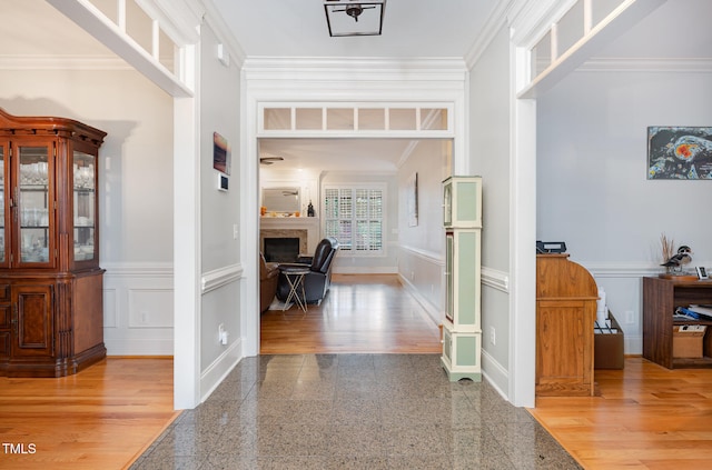 corridor with hardwood / wood-style flooring and crown molding