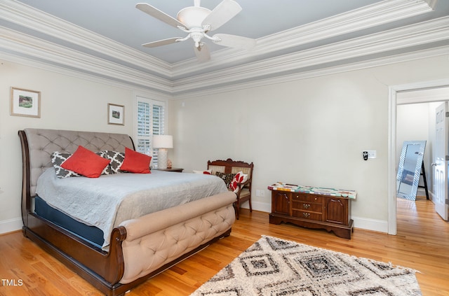 bedroom featuring light wood-type flooring, ceiling fan, and crown molding