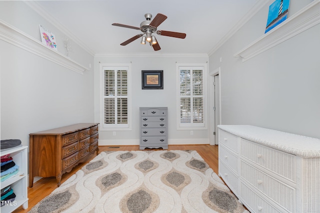 bedroom featuring ceiling fan, light hardwood / wood-style floors, and crown molding