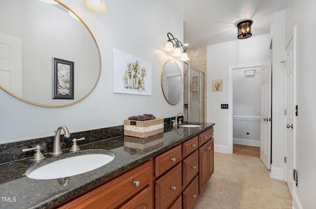 166 Weldon Dr, Clayton, NC 27520 - bathroom featuring double vanity, a shower stall, stone finish flooring, and baseboards