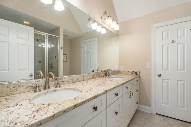 166 Weldon Dr, Clayton, NC 27520 - full bathroom with double vanity, a stall shower, baseboards, and vaulted ceiling