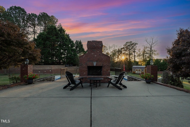 166 Weldon Dr, Clayton, NC 27520 - patio terrace at dusk with an outdoor brick fireplace and a patio