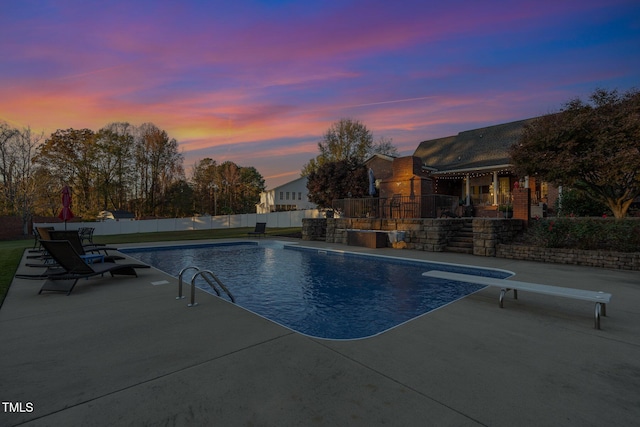 166 Weldon Dr, Clayton, NC 27520 - pool at dusk with a diving board and a patio