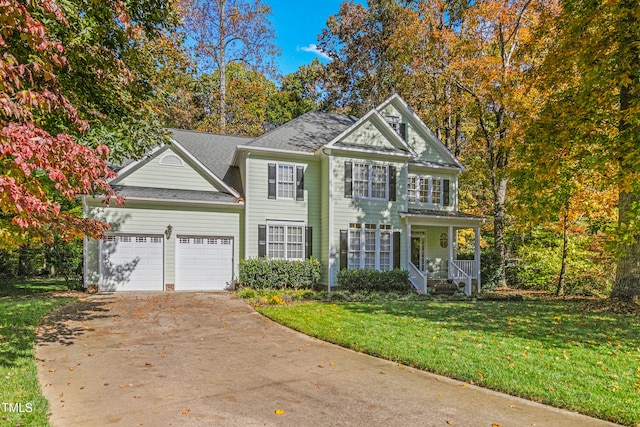 view of front facade with a porch, a front lawn, and a garage