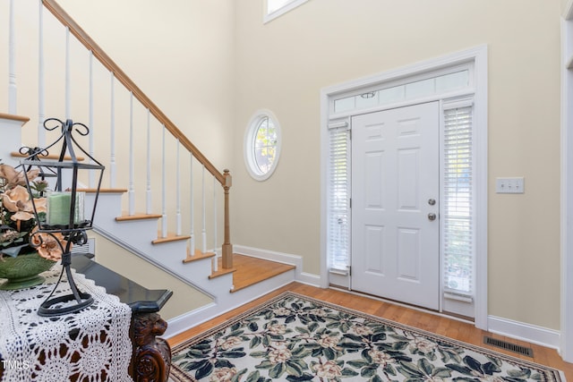 foyer entrance with a healthy amount of sunlight and wood-type flooring