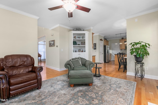 living room with crown molding, wood-type flooring, and ceiling fan