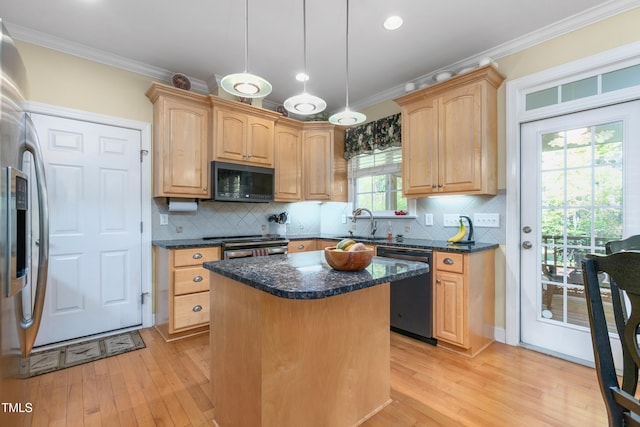 kitchen featuring black appliances, a center island, light wood-type flooring, and a healthy amount of sunlight