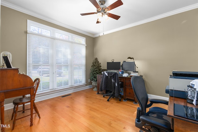 office area with crown molding, a wealth of natural light, and light wood-type flooring