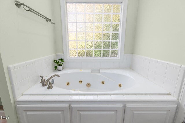 bathroom featuring a relaxing tiled tub