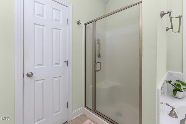 bathroom featuring an enclosed shower