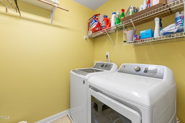 clothes washing area with separate washer and dryer