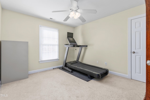 exercise room with light carpet and ceiling fan