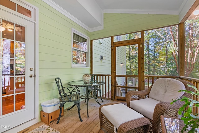 sunroom / solarium featuring lofted ceiling