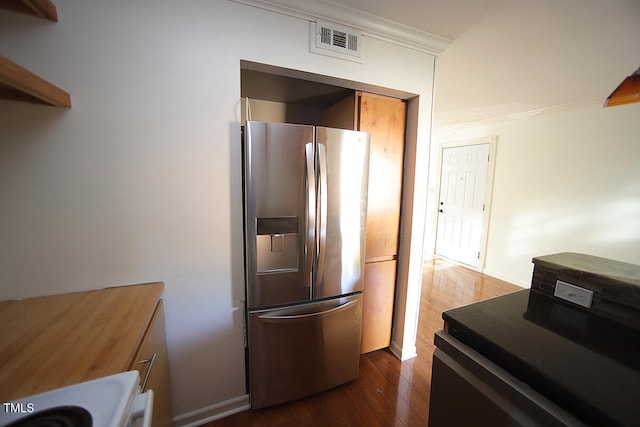 kitchen featuring crown molding, stainless steel fridge with ice dispenser, stove, dark hardwood / wood-style flooring, and electric range