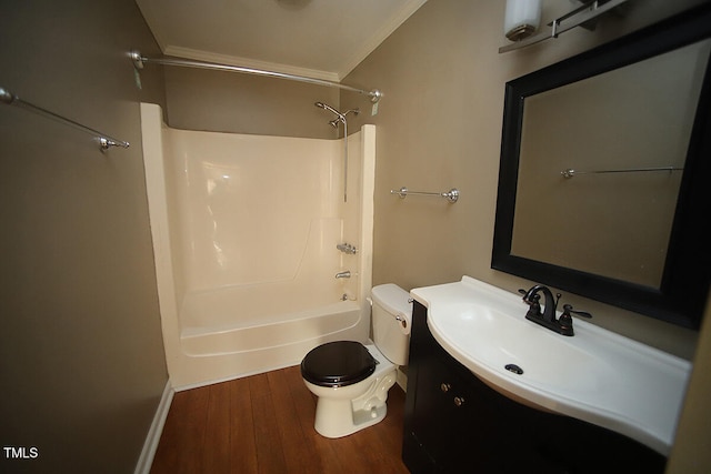 full bathroom with hardwood / wood-style flooring, washtub / shower combination, ornamental molding, vanity, and toilet