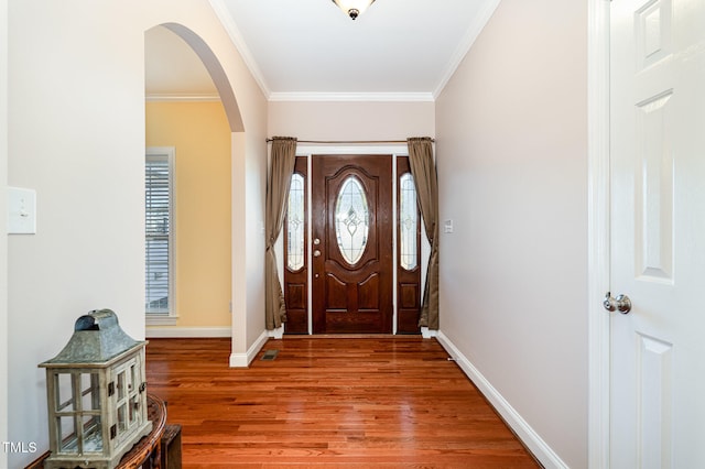 foyer with ornamental molding and hardwood / wood-style floors