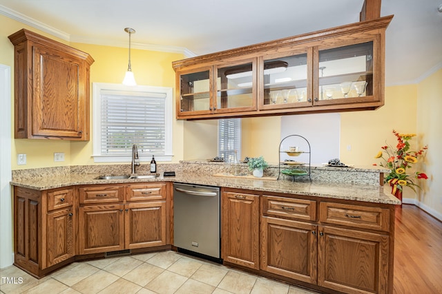 kitchen with dishwasher, sink, light stone counters, and crown molding