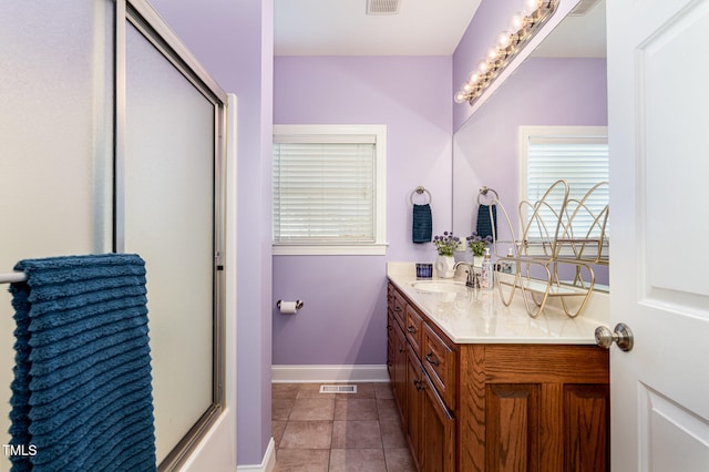 bathroom featuring tile patterned flooring and vanity