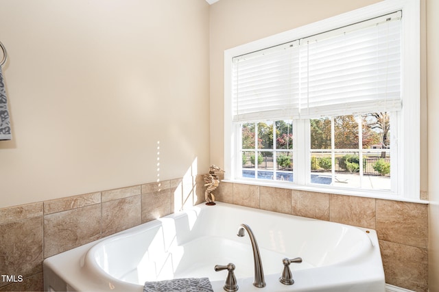 bathroom featuring a relaxing tiled tub