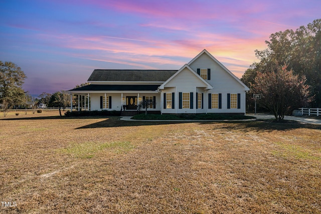 view of front of home featuring a porch and a yard