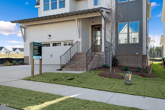 view of front of property with a front yard and a garage