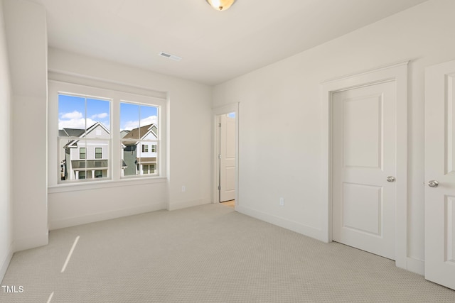 unfurnished bedroom with light colored carpet