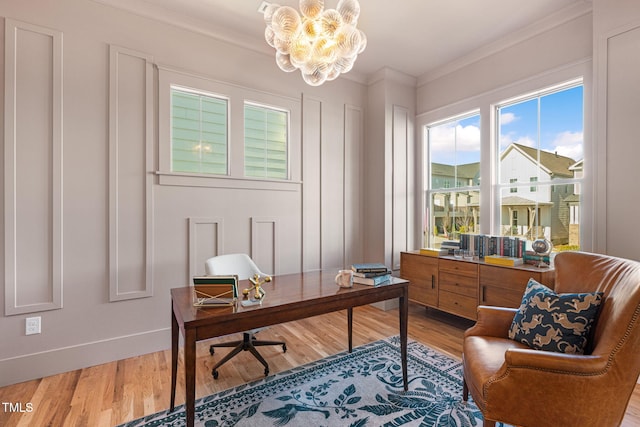 office featuring ornamental molding, wood-type flooring, and an inviting chandelier