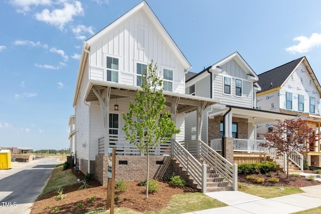 view of front of home featuring a porch and central AC