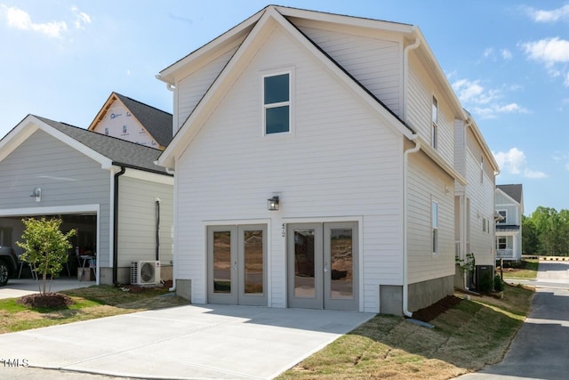 exterior space with a garage and ac unit