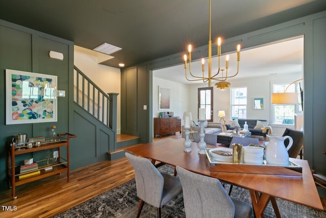 dining room featuring hardwood / wood-style flooring and an inviting chandelier